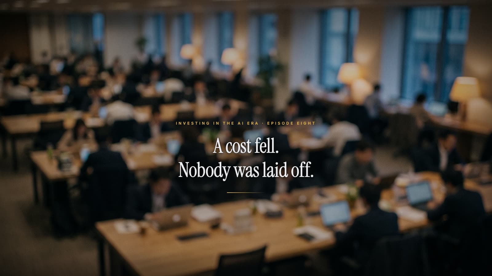 A dim open-plan office at night with one empty chair in the foreground; the title reads: A cost fell. Nobody was laid off.